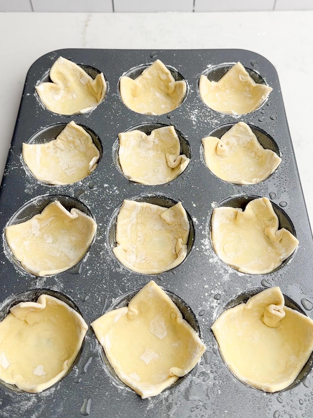 puff pastry squares in a muffin tin