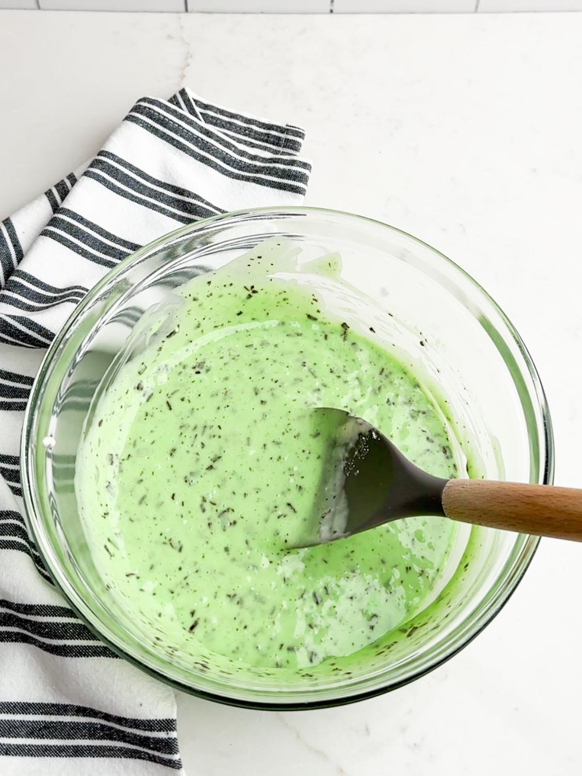 mint cake batter in a clear bowl