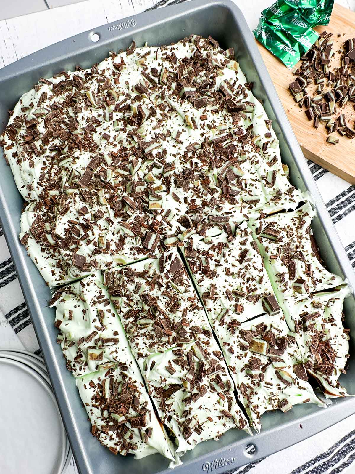 overhead view of mint chocolate cake topped with Andes mints and shaved chocolate