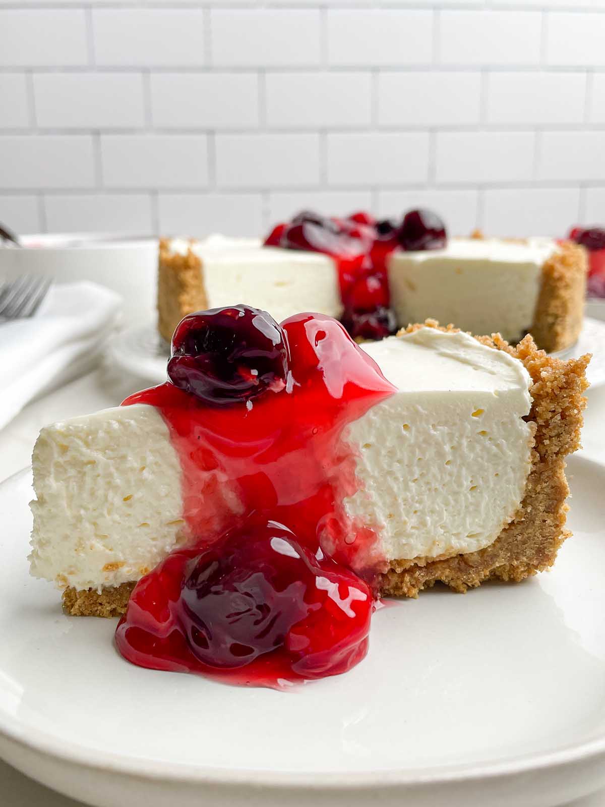 piece of no-bake cheesecake with cherry topping.