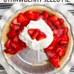 strawberry jello pie in white pie plate with whipped cream