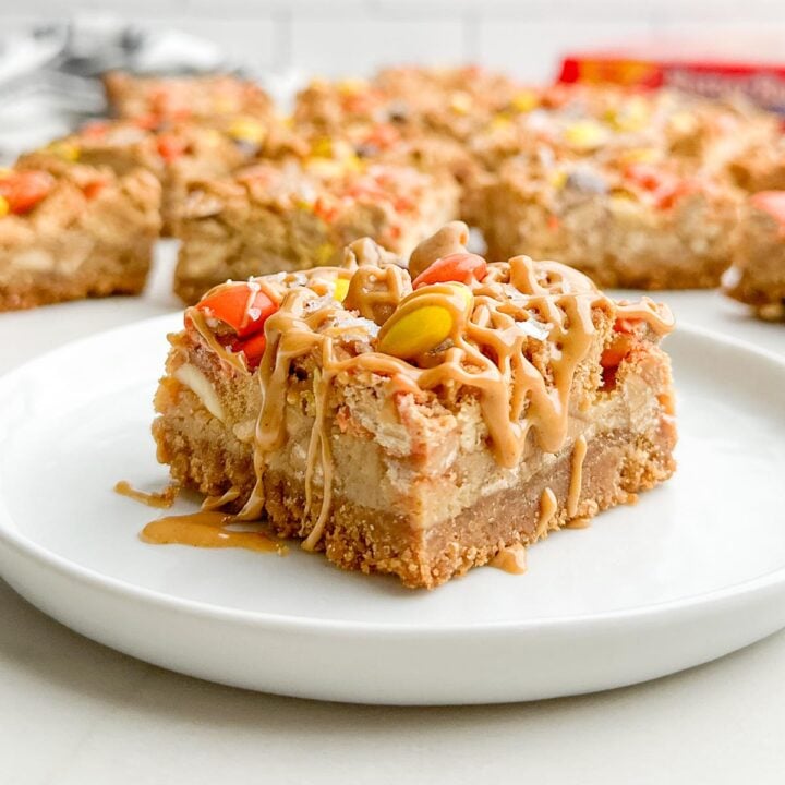 A Nutter Butter bar drizzled with peanut butter on a white plate.