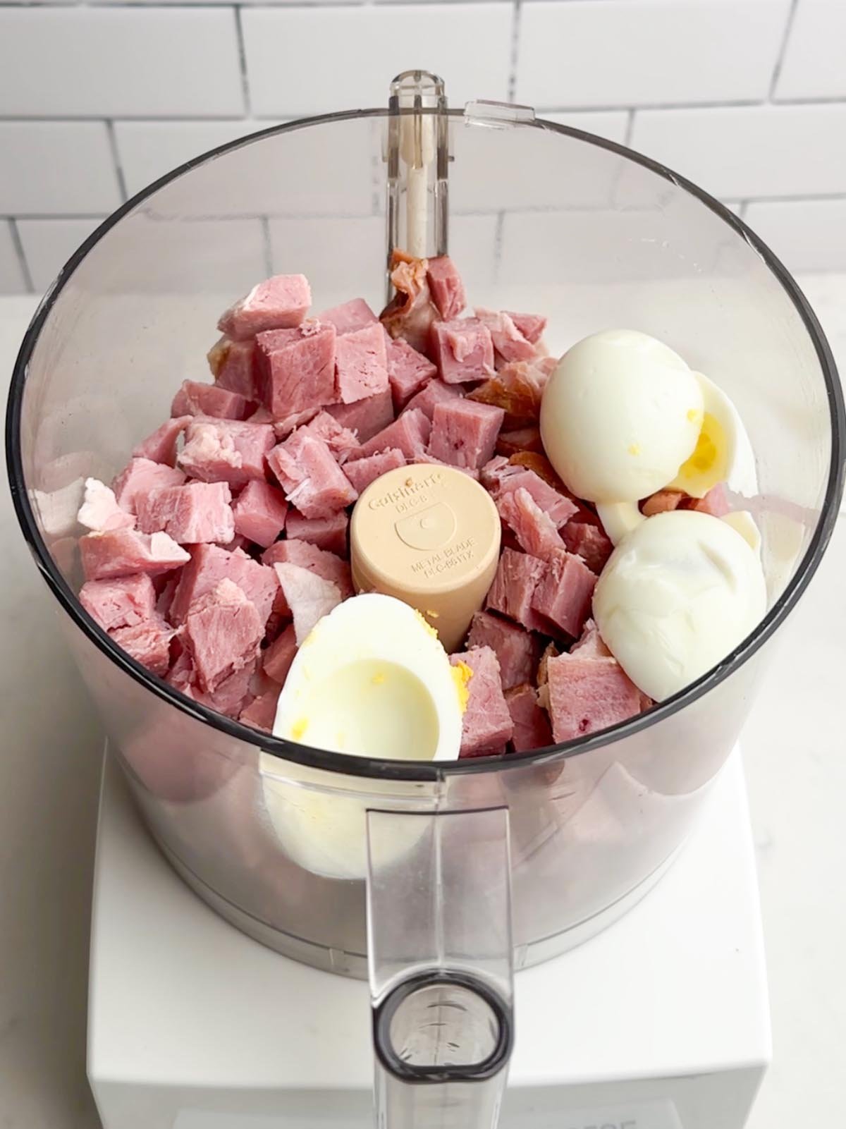 cubed ham and egg whites in a food processor