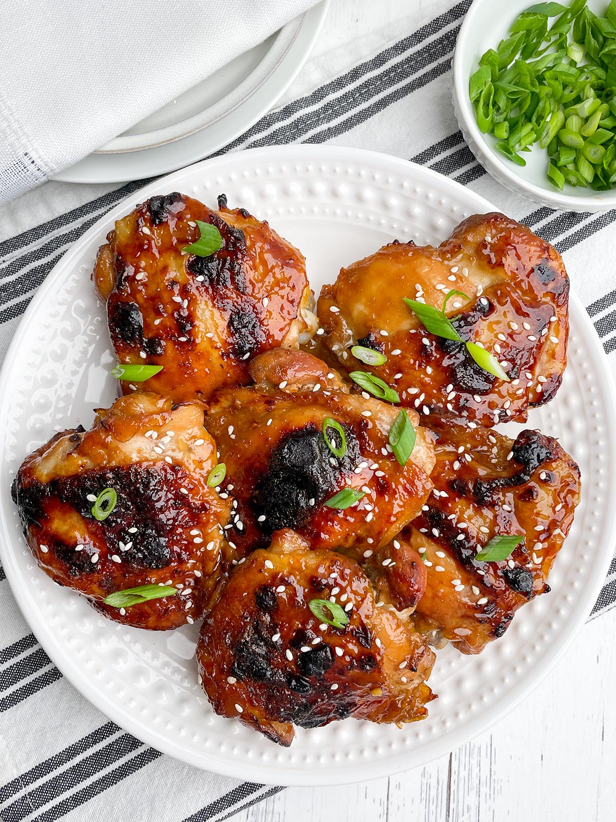 oven baked teriyaki chicken thighs on a white plate