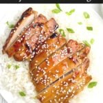 sliced oven baked teriyaki chicken with green onions and sesame seeds on a bed of rice