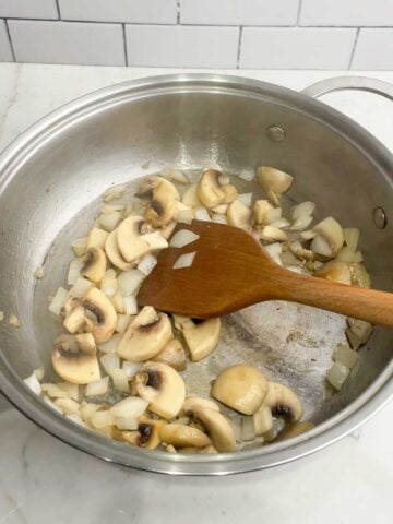 sauteed mushrooms and onions in a skillet.