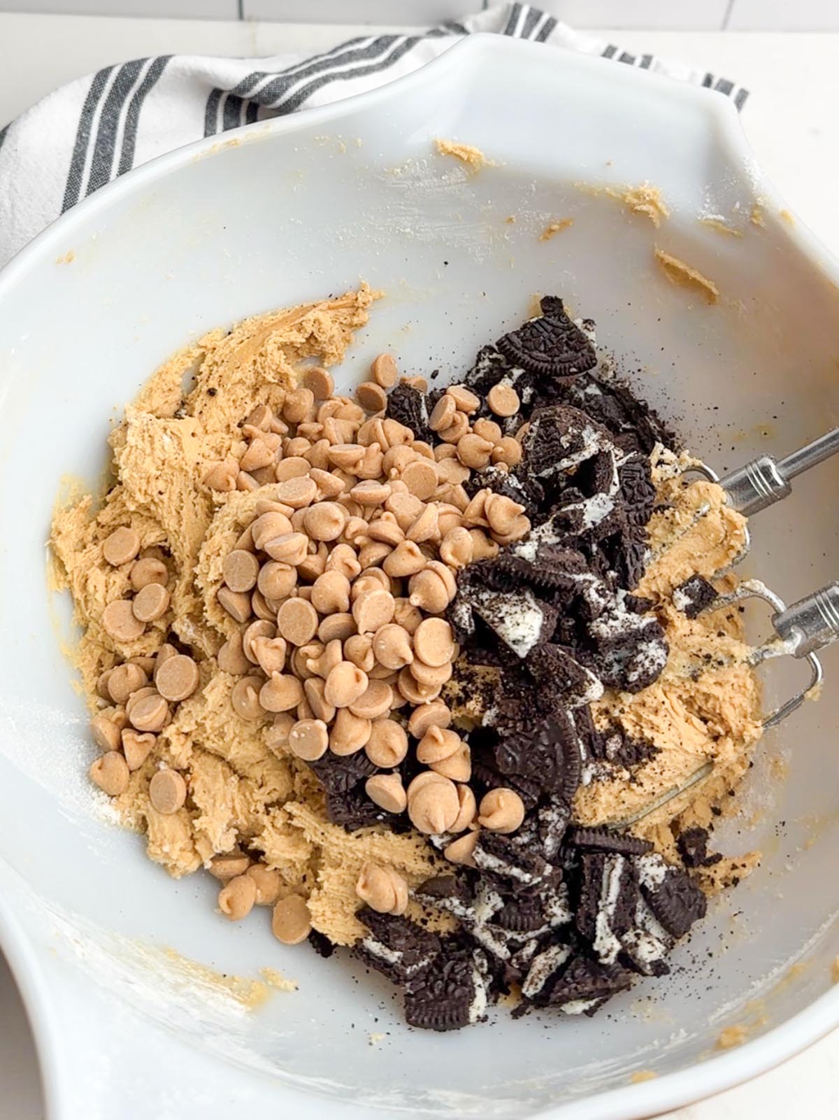 Peanut butter Oreo cookie dough in white mixing bowl.