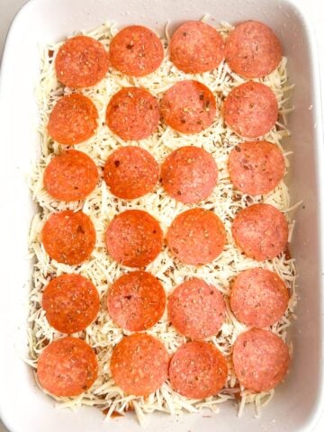 unbaked pizza casserole in a baking dish.