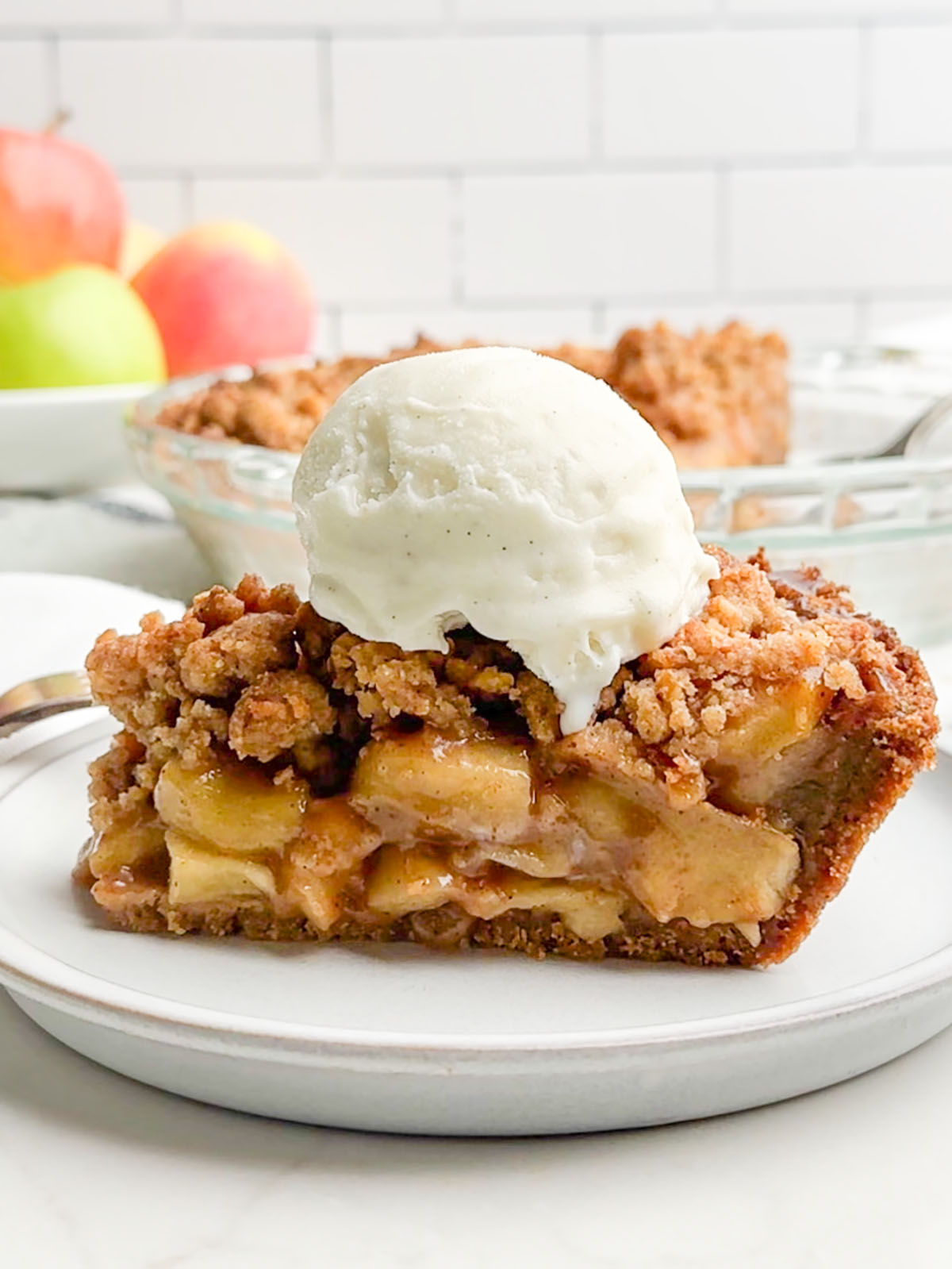 side view of apple pie with graham cracker crust.