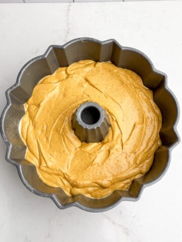 pumpkin cake with yellow cake mix batter in a Bundt pan.