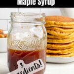 jar of pumpkin syrup in front of a stack of pancakes.
