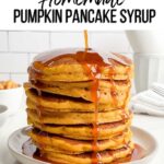 pumpkin syrup pouring over stack of pancakes.