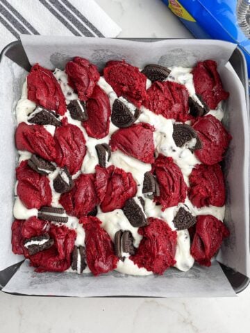 unbaked red velvet brownies from cake mix in a square baking pan.