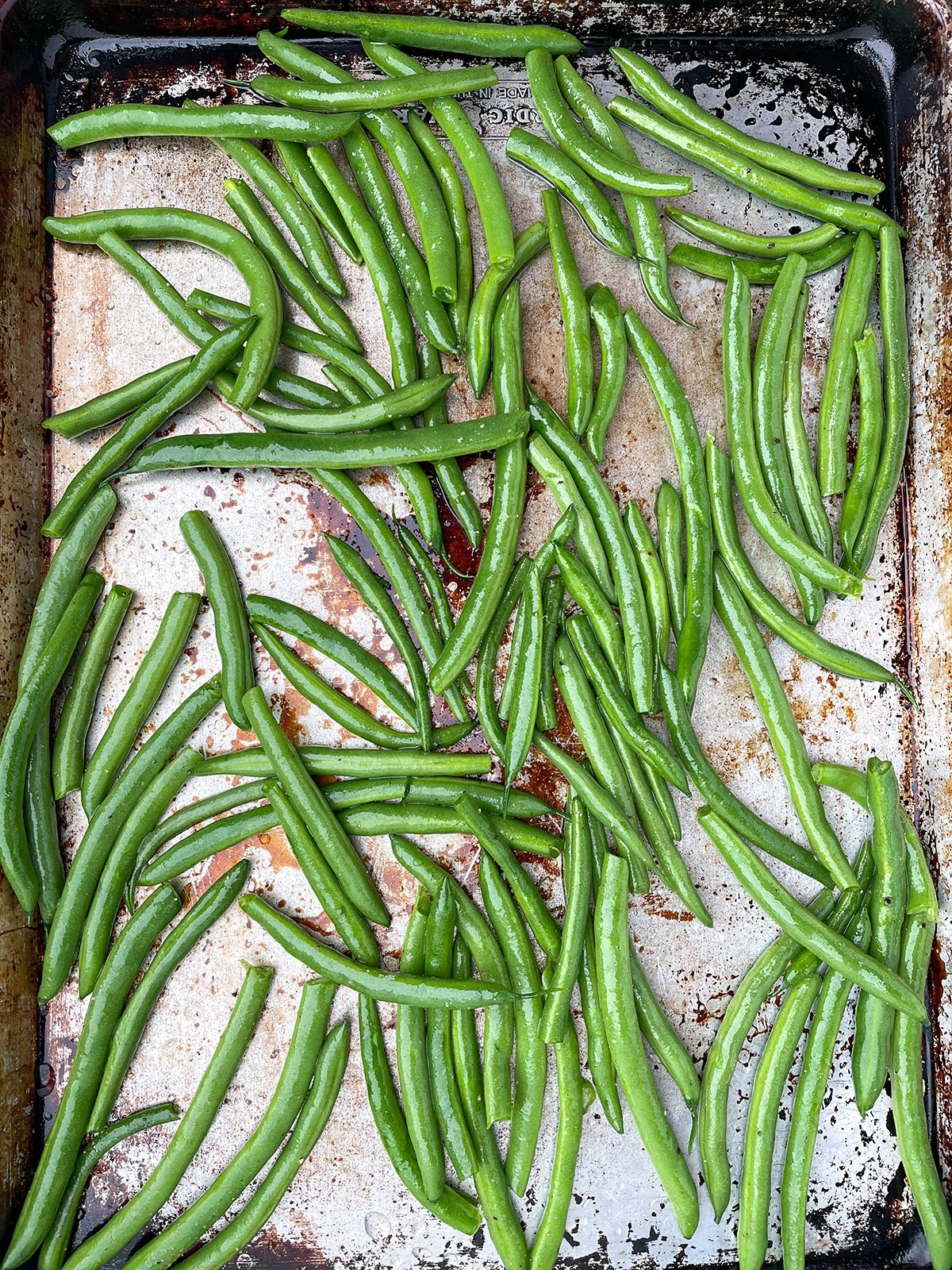 green beans on a sheet pan with olive oil