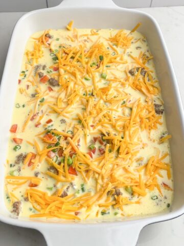unbaked egg casserole with white casserole dish.