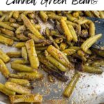 sauteed canned green beans in a stainless steel skillet.