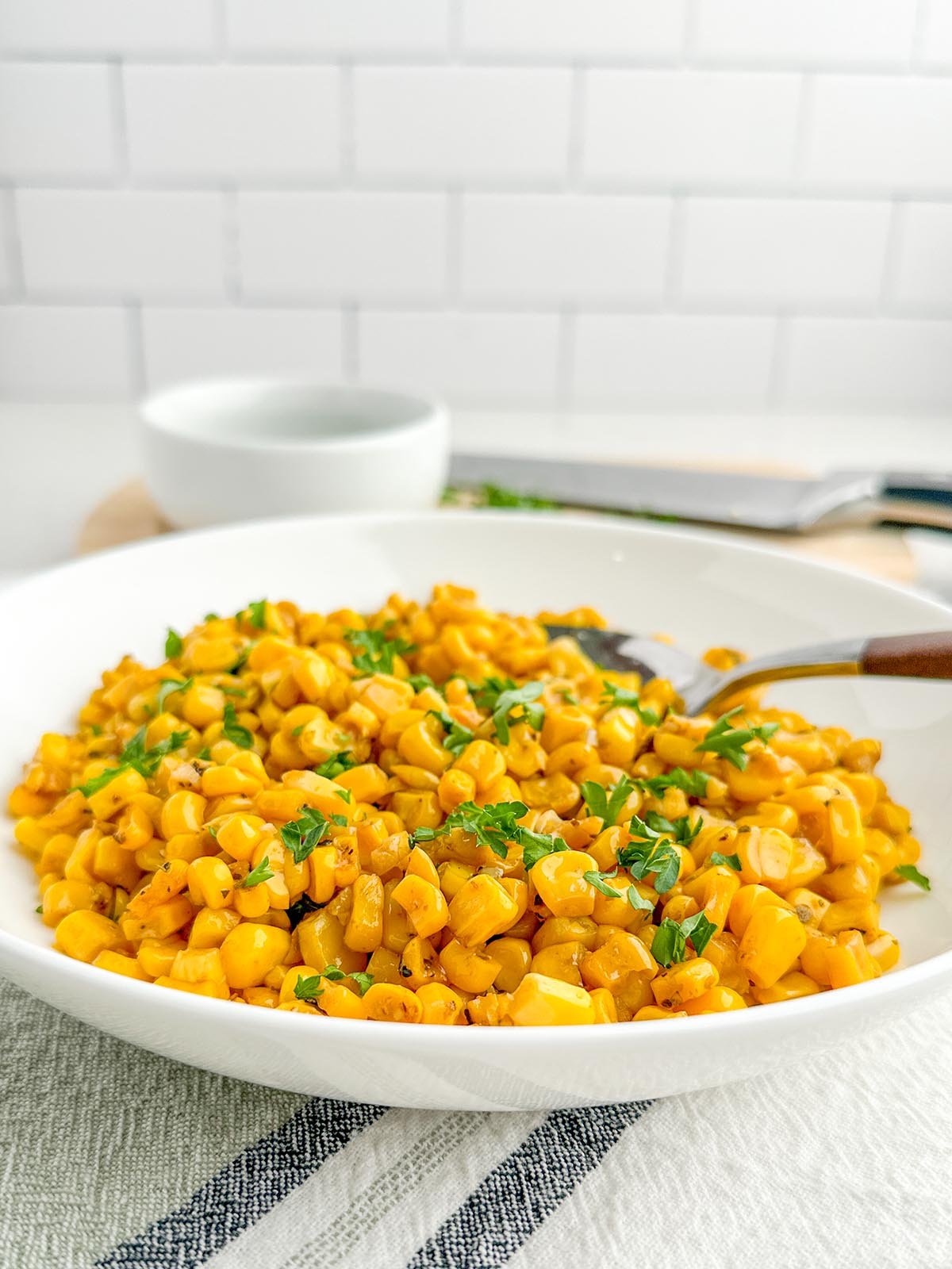 sauteed canned corn in a white bowl.