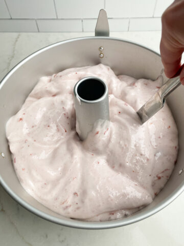 strawberry angel food cake batter in a tube pan.