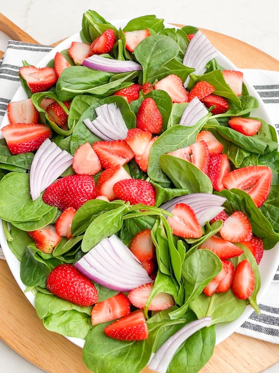 strawberry goat cheese salad on a white platter