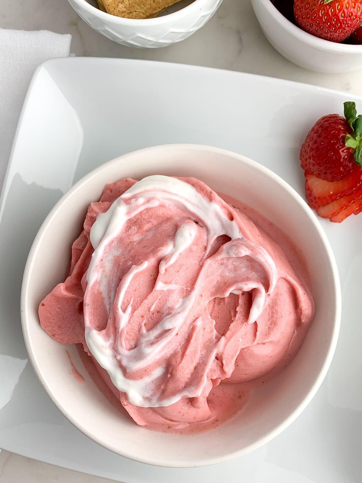 Strawberry Smoothie Bowl in a white bowl with a swirl of Greek yogurt on top