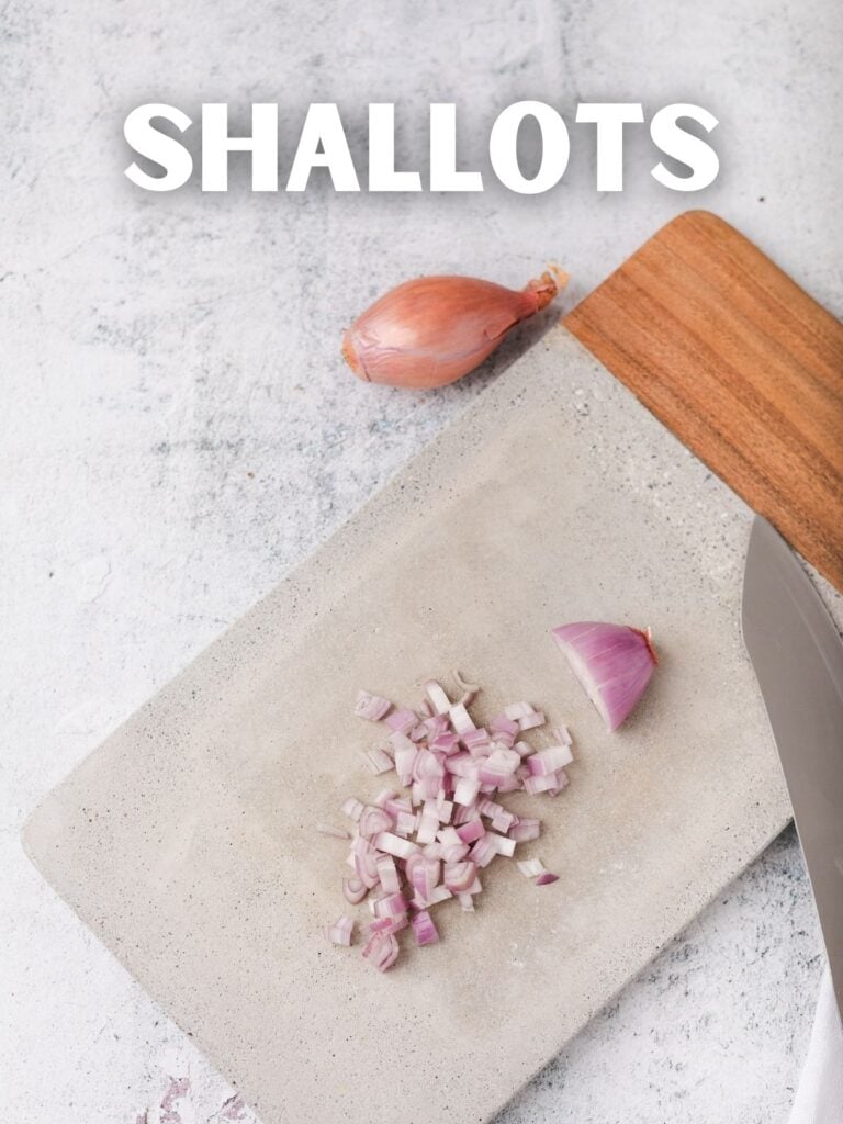 diced shallts on a cutting board with a knife