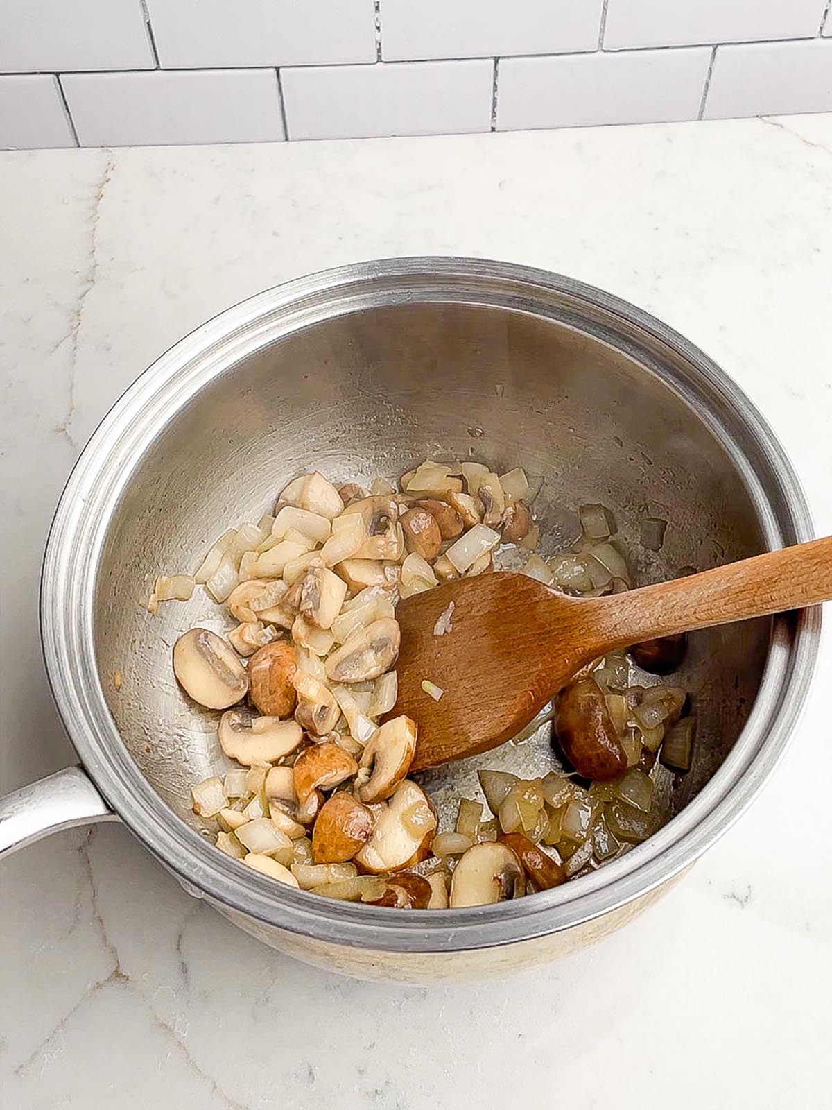 mushrooms and onions in saucepan