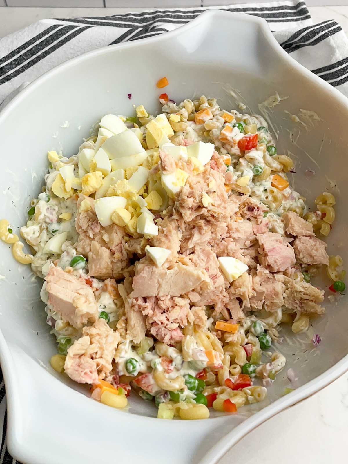 tuna macaroni salad ingredients in a white bowl