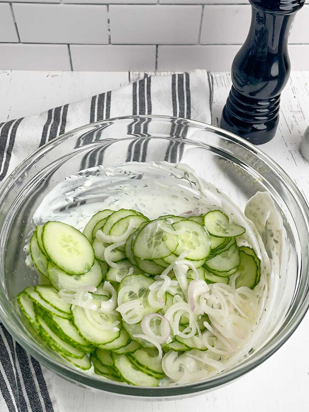 clear bowl with cucumber slices and shallots