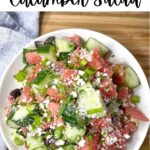 white bowl with watermelon goat cheese salad with cucumbers