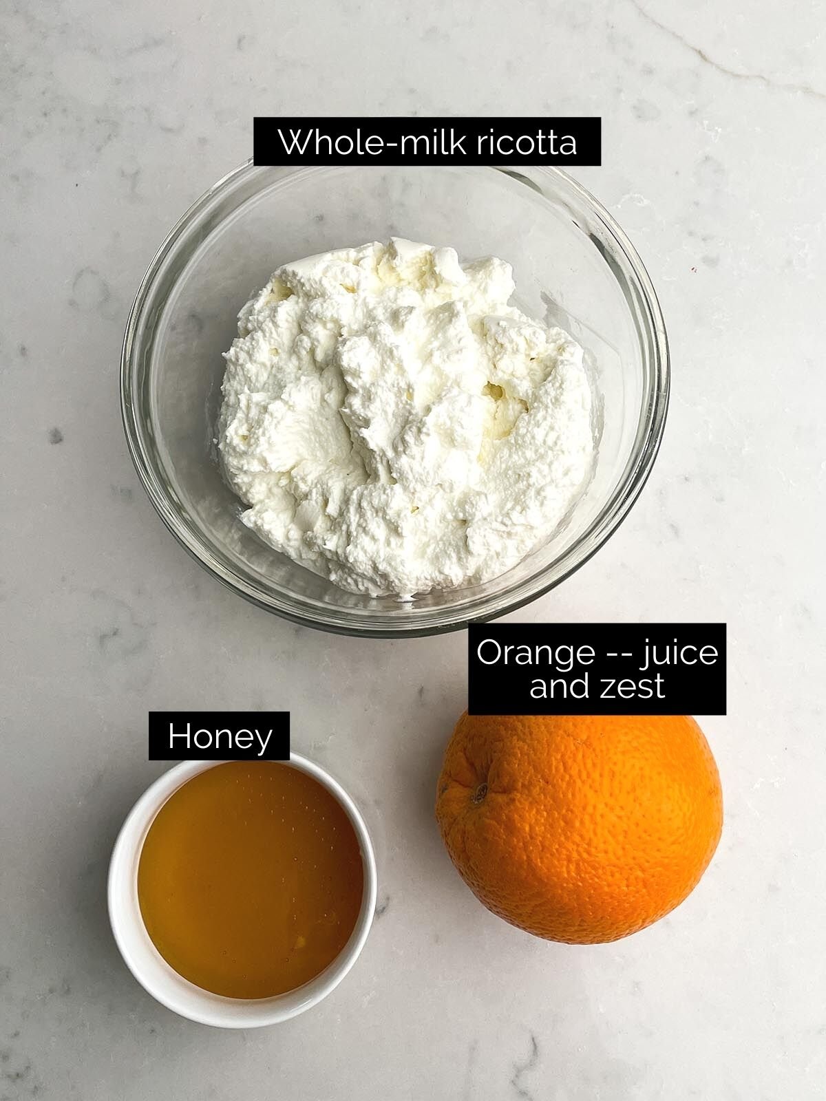 Whipped ricotta ingredients on white countertop.